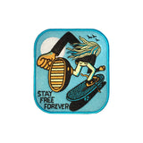 An embroidered patch of a whimsical cartoon skateboarder seen from the back. "Stay Free Forever" is sewn into the blue background in the bottom right corner.