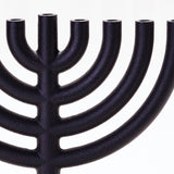 A zoomed in shot of the Menorah showing the rough texture of the cast iron.