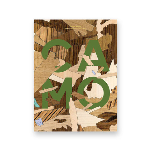 Book cover featuring fragments of various wood chips scattered with 2 rows of 2 large green letters emerging from the center: C A (first row) M O (second row).