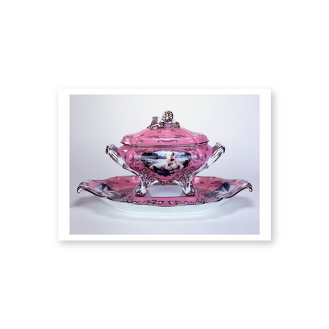A pink glazed rococo-style porcelain soup tureen with an embellished cover sits on a coordinating pink stand. Overlaying the pink background is a branch and leaf motif painted in black and platinum. The front center of the tureen features a photo transferred  image of Cindy Sherman dressed as Madame de Pompadour. Two additional photo transfers are printed on either sIde of the stand. 