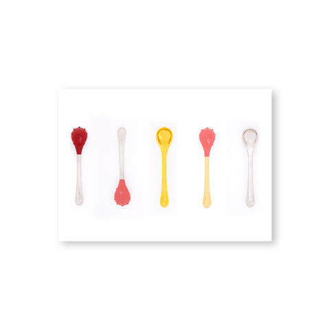 A horizontal postcard with a white border features a row of six, evenly spaced translucent spoons in clear or yellow, with round, textured bowls with or without a reddish coating, and easy-to-grip handles. 