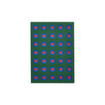 Dark green greeting card with geometric cutouts: rows of concentric circles in blue and red.