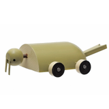 Walrus Toy Side view of a rollable toy walrus hand-made from wood and hand-painted in shades of brown with wheels for feet.
