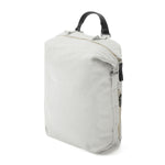 Side view of the light gray medium sized zip pouch backpack. Hooks on the side of the backpack allow wearer to adjust height/ size of pack. Black leather top handle