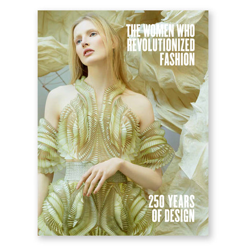 Book cover featuring a white woman off-centered to the left, with long blond hair, glancing over to the left side of the book with her head tilted toward the same direction. Her body faces forward, dressed in an futuristic-like halter gown, which blends with her hair color. The background is a large flowing fabric which also is similarly colored to the gown and hair of the model. The title is in white text in the top right corner