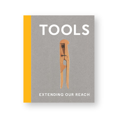 Catalog cover of Tools: Extending our Reach. Yellow spine, natural chipboard face with "TOOLS" in white and centered image of a wood clip