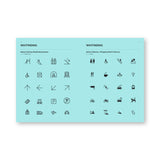 Bright light blue interior book spread featuring a grid of icons under header "Wayfinding" on each page. Each page's icons are in a different graphic style.