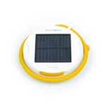 Solar-panel side up, disk-shaped light with its flexible yellow arm wrapped around it.