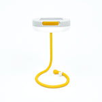 white, dish-shaped light supported by its extended, yellow arm, which is looped to stand upright.