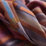 Close-up of a colorful striped fabric with a patterned edge.