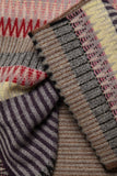 Close-up of patterned knitted fabric with a focus on texture and color.