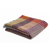 Folded plaid blanket with multicolor pattern on a white background