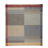 Plaid patterned rug with a mix of colors on a white background