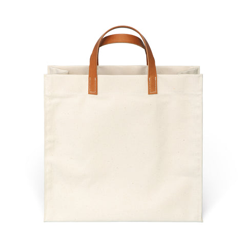  Square shaped canvas bag in natural with medium brown leather handles