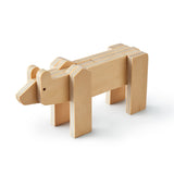 3/4 view of a minimalist bear made up of flat plywood pieces fitted together. The bear is standing on four legs, its' pieces are primarily rectangular with rounded ends for the shoulders, ears, and nose  Lines between plywood layers are blue.