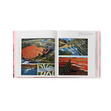 Book spread open to reveal inside pages. This spread shows five colorful renderings of landscape architectural designs from an aerial view.