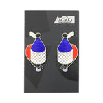 Pair of stainless steel earrings with enamel detailing. Enamel on the earrings are red, white, and blue. The earrings are similarly shaped like a vintage air pump or perfume bottle and include small graphic detailing throughout.