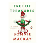Cream colored book cover with a playful elf Christmas ornament hanging in the center with title information in green letters above and author in red letters below