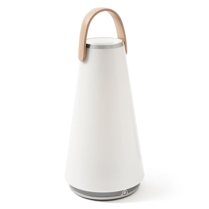 Uma Sound Lantern on a white background, with tapered, conical body, rounded silver speaker base, flat silver rimmed speaker/dimmer top and graceful U-shaped wooden carrying  handle.