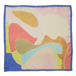 A pastel colored silk scarf with blue frame border. The interior pattern includes soft curved shapes in yellow, orange, light blue, blush, and coral. The brands logo is printed on the bottom left corner of the scarf.