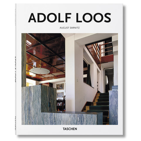 White book cover with photograph of an architectural interior with stone and wooden banisters and disc shaped hanging light fixture. Title above in black sans serif letters