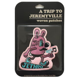 A blister pack with a Jethro walking patch inside. Brand logo, "A Trip to Jeremyville" is embossed at the top.