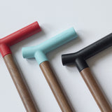 Close up of three canes with angular handles. The hand hold is smooth and straight, with a small bent piece where the cane body meets the handle