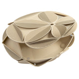 Beige clutch decorated with an elaborate pattern of sculptural plant leaves, each is perforated with tiny holes.  