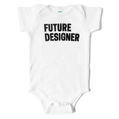 White baby onesie with bold text in black that reads 'FUTURE DESIGNER'