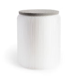 Softseat Stool Side view of a simple yet  elegant, white, cylinder-shaped stool made from a curved accordian of vertical paper pleats, topped by a gray felt disc seat.