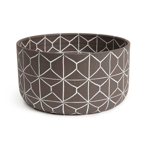 Matte brown ceramic bowl with tall sides and an etched out white geometric pattern 