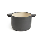 Small matte black ceramic casserole dish with 2 handles and a glossy, neutral colored inside