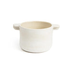 Small matte white ceramic casserole dish with 2 handles and a glossy, neutral colored inside