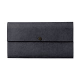 A rectangle shaped envelope style wallet made out of a cloth material and featuring a brass snap closure.