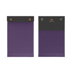 Front and back view of the palm-sized refillable notepad with snap closure in purple with dark purple border. The brand name and logo are embossed at center back in gold.