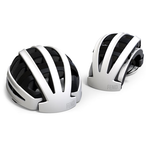 An image of two white Fend bike helmuts. One is shown in its collapsable position while the other is shown open.