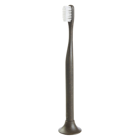 dark brown toothbrush with matching color, round shaped stand.