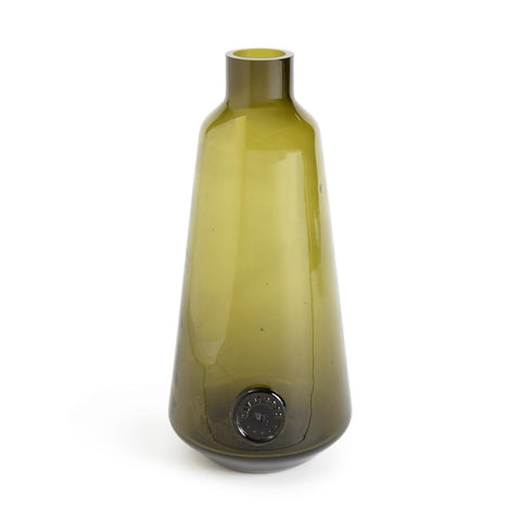 Olive green carafe featuring a stout body and narrow rimmed tip. A marked is stamped at the base and resembles a coin.