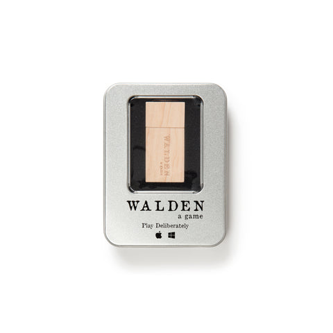 A rectangular metal tin with rounded edges and a window revealing the natural wood USB game plug inside. The Walden game logo is imprinted in black under the window.