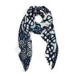Square silk scarf features blue and black vibrant patterns of sound over a white background.