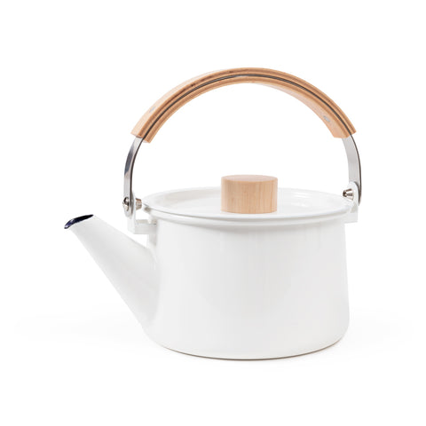 Side view of a bright white minimalist enamel Kaico Kettle on a white background with a wide, straight-sided cylindrical body, angled pour spout, arced steel carrying handle with a wooden grip, and flat lid with a light wood, easy-to-grasp cylindrical knob.