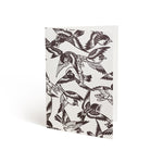 Printed in brown ink against a white background, the front of a card is covered in a repeating bird pattern that bleeds off the edges.