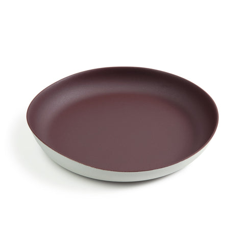 A large dinner plate featuring a dark red matte interior and white matte exterior. The rim of the plate is extended upward allowing for a deep dish styled plate good for gravy and other runny foods.