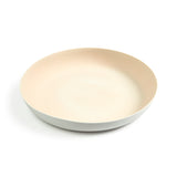 A large dinner plate featuring a tan colored matte interior and white matte exterior. The rim of the plate is extended upward allowing for a deep dish styled plate good for gravy and other runny foods.