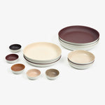 Cornwall collection featuring the small bowl as well as the small, medium, and large plate. Colors included are dark red and muted shades of brown. The collection includes both a glazed or matte finish.