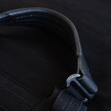 Close up view of Bananatex Roll Pack black leather removable handle