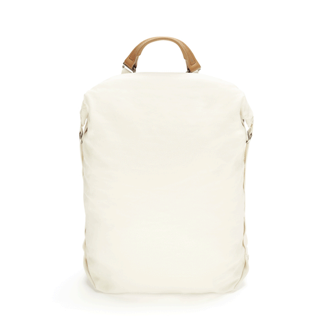 White backpack with flexible roll-top closure and a leather handle