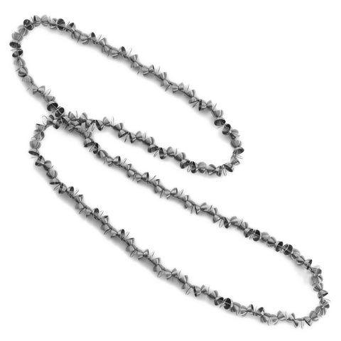 A long necklace that can be wrapped twice around the neck. Made from stainless steel beads shaped as halves of a sphere. 