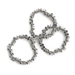 Three bracelets with beads shaped as halves of a sphere assembled with rings, hold together by a stainless steel spring.