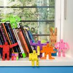 Nine Micro Cubebots posed in various positions on a bookshelf.